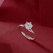 Éclat Entrelacé Moissanite Ring on a red fabric background